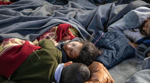 Children sleeping under blankest at a mosque in the Al-Midan district of Aleppo, Syria